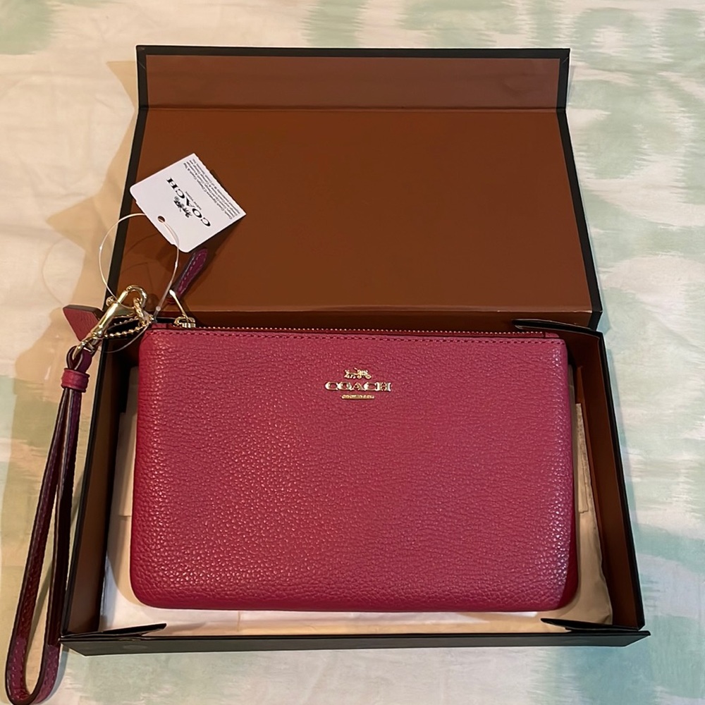 Pink Coach pebbled leather wristlet